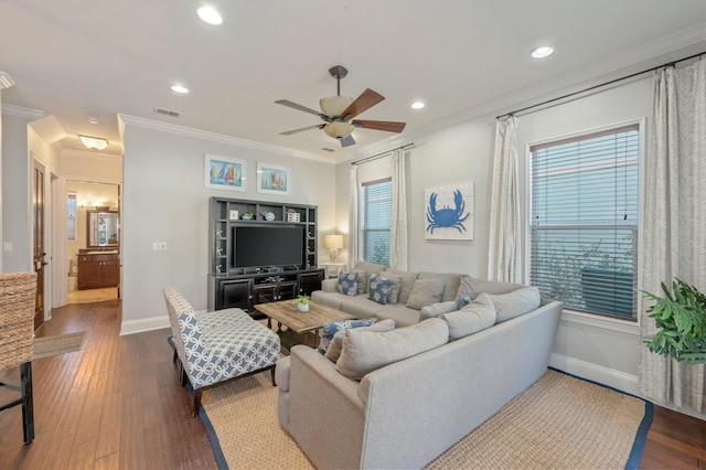 living room with ceiling fan, dark hardwood / wood-style flooring, a healthy amount of sunlight, and ornamental molding