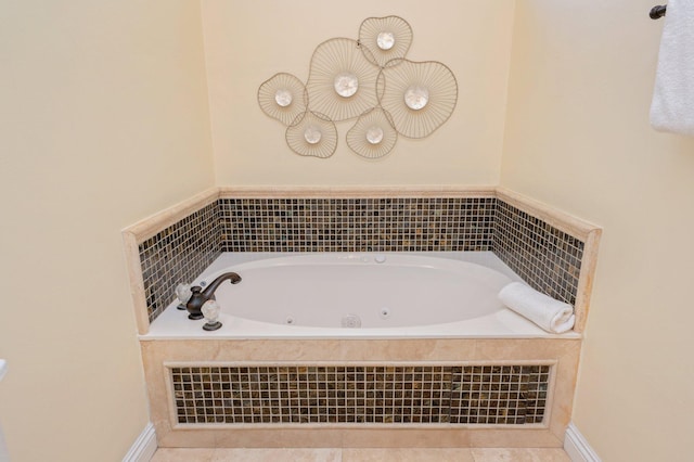 bathroom featuring tile patterned flooring and a relaxing tiled tub