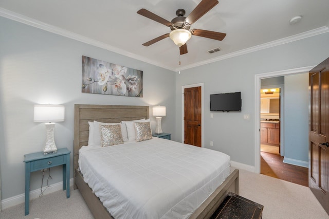 carpeted bedroom with ceiling fan and ornamental molding