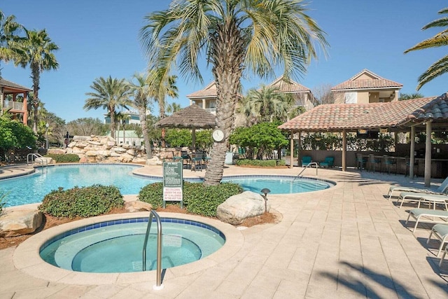 view of swimming pool with a gazebo, a hot tub, and a patio area