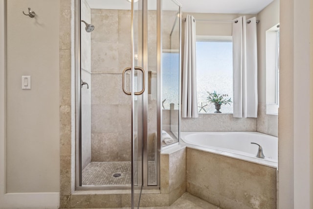 bathroom with shower with separate bathtub