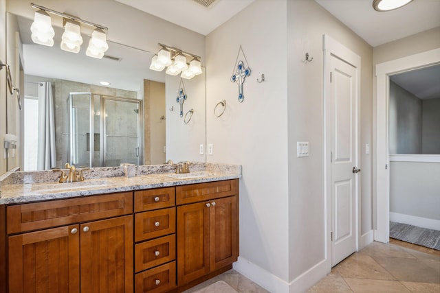 bathroom featuring vanity, tile patterned flooring, and an enclosed shower