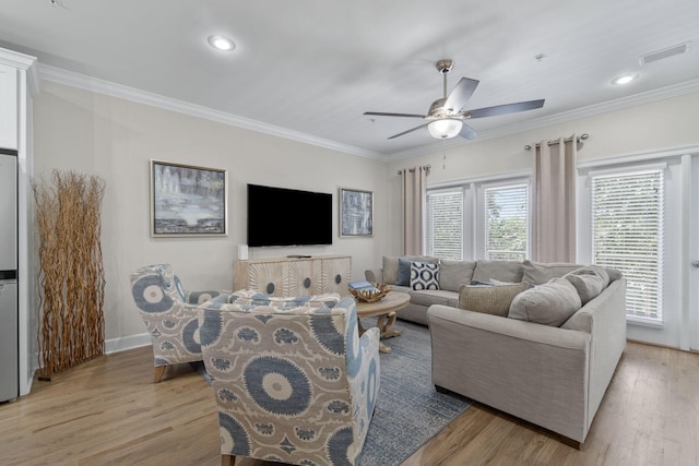 living room featuring light hardwood / wood-style floors, ceiling fan, and crown molding