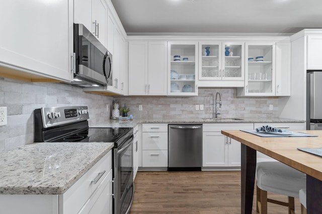 kitchen featuring white cabinets, appliances with stainless steel finishes, backsplash, and sink