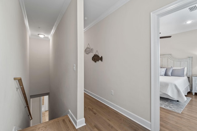 hall featuring light wood-type flooring and ornamental molding