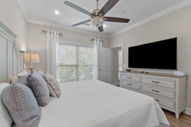 bedroom featuring ceiling fan, light hardwood / wood-style flooring, and crown molding