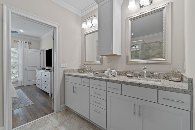 bathroom featuring vanity, tile patterned floors, an enclosed shower, and crown molding