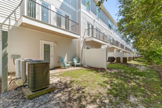 exterior space with a balcony and central air condition unit