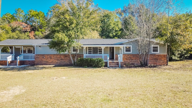 ranch-style house featuring a porch, a front lawn, and brick siding