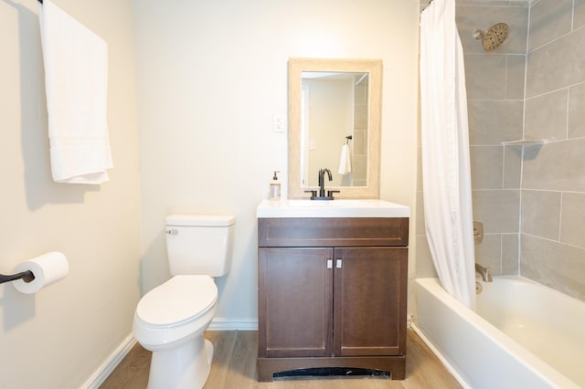 bathroom with toilet, wood finished floors, vanity, baseboards, and shower / tub combo with curtain