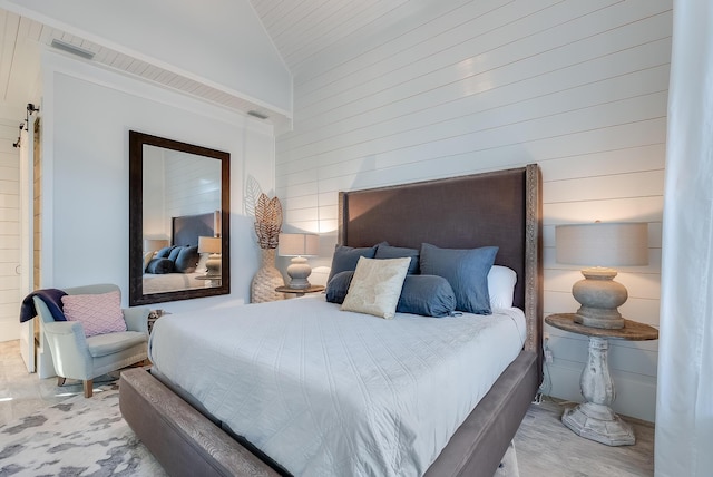 bedroom featuring wooden walls and vaulted ceiling