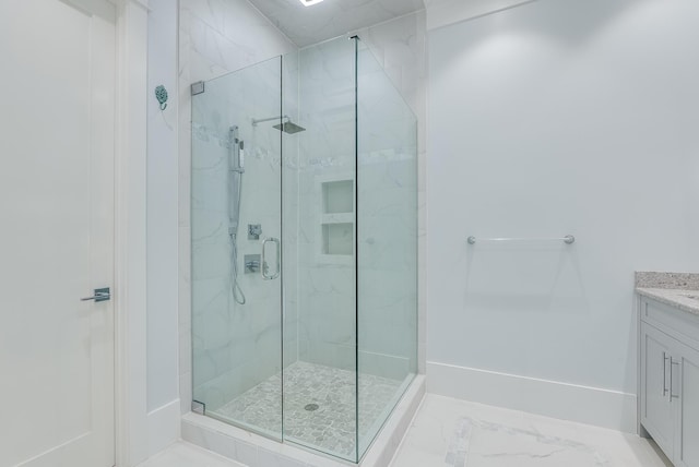 bathroom featuring vanity and a shower with shower door