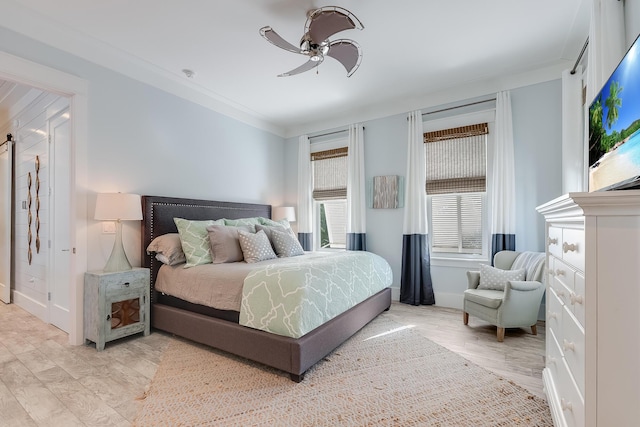 bedroom with light hardwood / wood-style flooring, ceiling fan, and ornamental molding