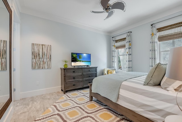 bedroom featuring ceiling fan, crown molding, and light hardwood / wood-style flooring