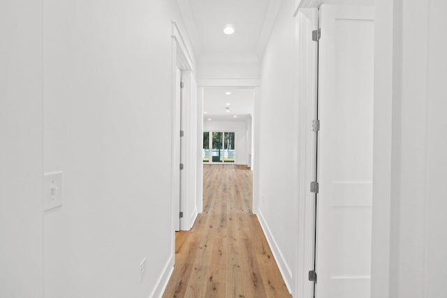 corridor with ornamental molding, light wood-type flooring, recessed lighting, and baseboards