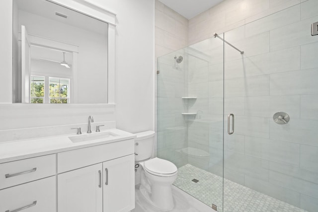 full bathroom with visible vents, vanity, a shower stall, and toilet