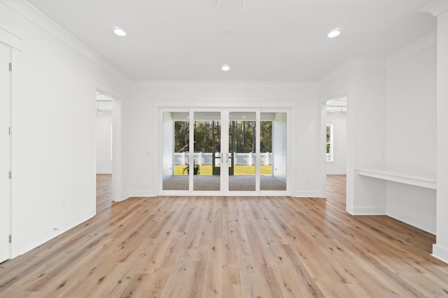 empty room with ornamental molding, recessed lighting, light wood-style floors, and baseboards