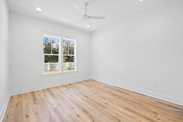 unfurnished room featuring baseboards, wood finished floors, and recessed lighting