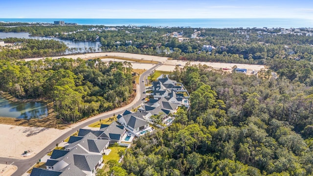 bird's eye view featuring a water view and a view of trees