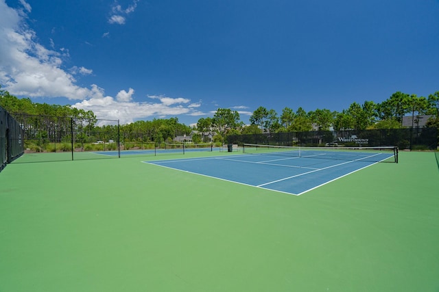 view of sport court featuring fence