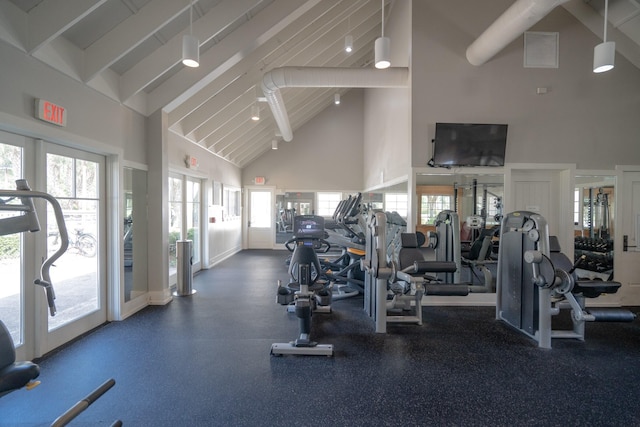 workout area featuring high vaulted ceiling