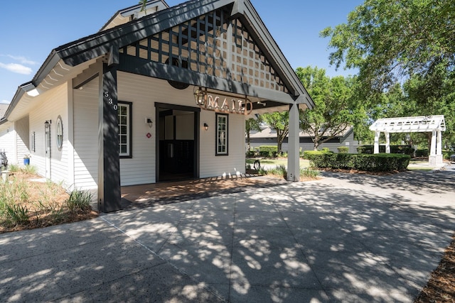 view of front of property with a pergola