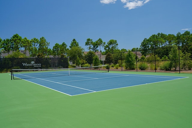 view of tennis court with fence