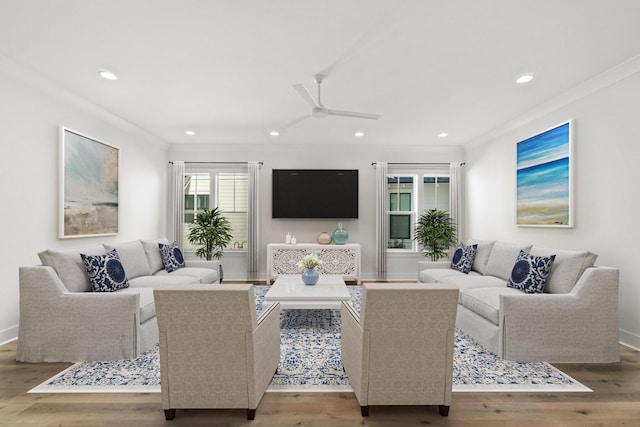 living room featuring ceiling fan, ornamental molding, wood finished floors, and recessed lighting