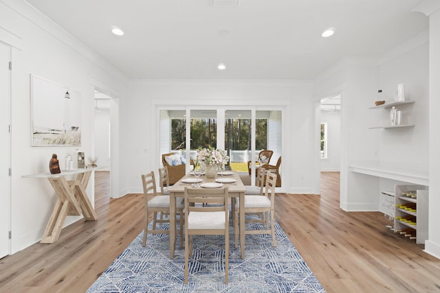 dining space featuring baseboards, ornamental molding, recessed lighting, and light wood-style floors