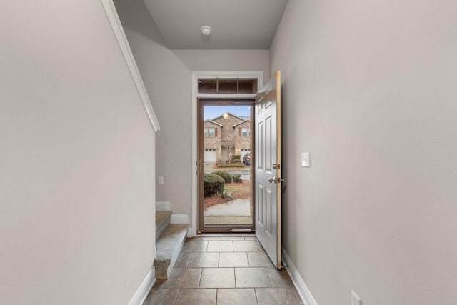 doorway with light tile patterned flooring