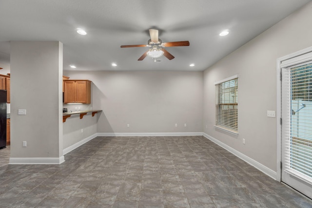 unfurnished living room featuring ceiling fan