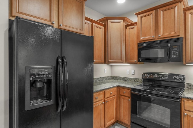 kitchen with stone counters and black appliances