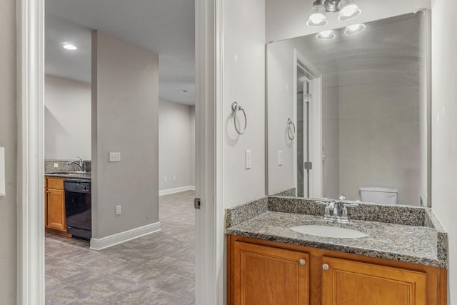 bathroom with toilet and vanity