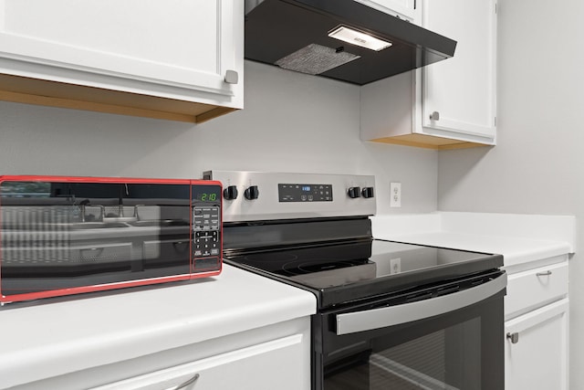 kitchen with white cabinets and stainless steel range with electric stovetop