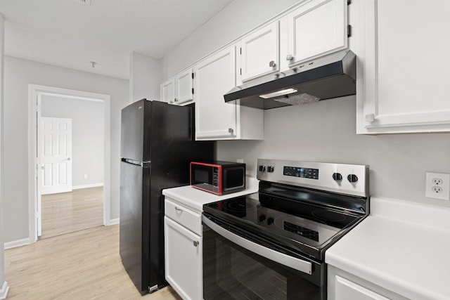 kitchen with white cabinetry, light hardwood / wood-style flooring, black appliances, and a textured ceiling