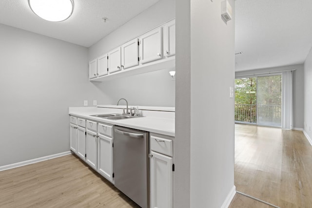 kitchen with light wood-type flooring, white cabinetry, stainless steel dishwasher, and sink