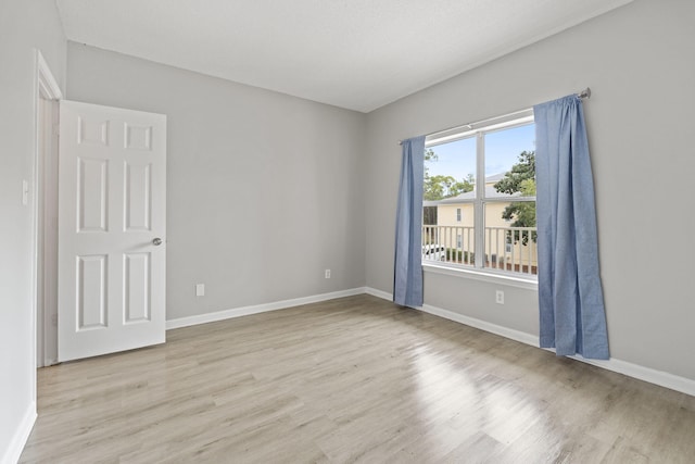 empty room with light hardwood / wood-style floors