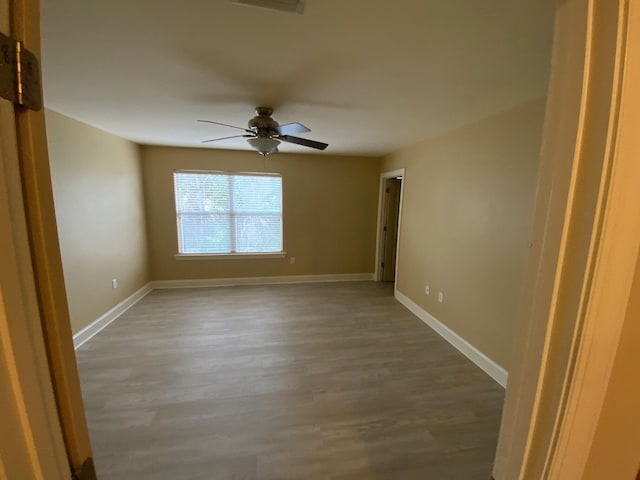 unfurnished room featuring ceiling fan and wood-type flooring