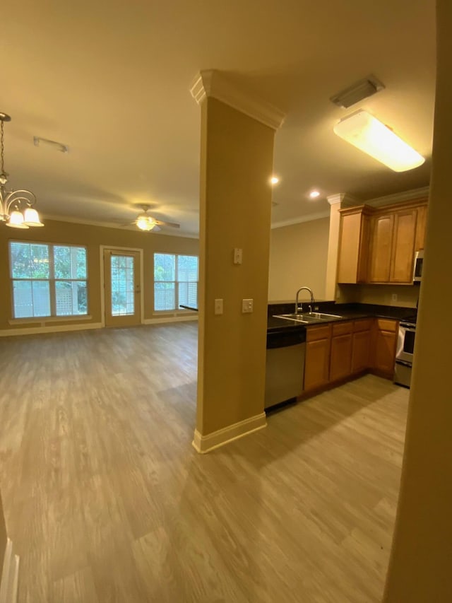 kitchen with sink, hanging light fixtures, light hardwood / wood-style floors, appliances with stainless steel finishes, and ornamental molding