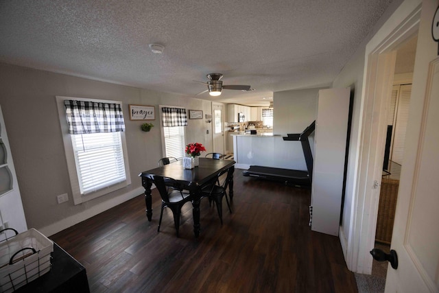 dining room featuring ceiling fan, dark hardwood / wood-style flooring, and a textured ceiling