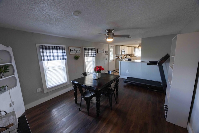 dining area featuring ceiling fan, dark hardwood / wood-style floors, and a textured ceiling