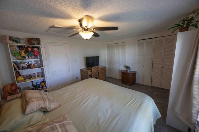 carpeted bedroom featuring multiple closets, ceiling fan, and a textured ceiling