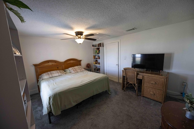 bedroom with ceiling fan, dark carpet, and a textured ceiling