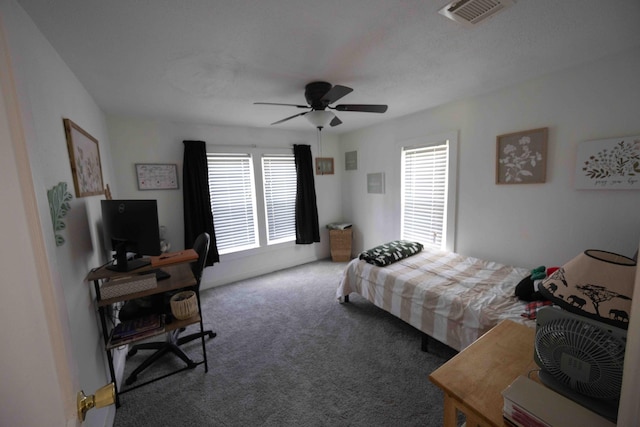 bedroom with carpet, multiple windows, and ceiling fan