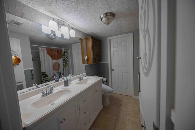 bathroom with tile patterned flooring, a textured ceiling, toilet, vanity, and a shower with shower curtain