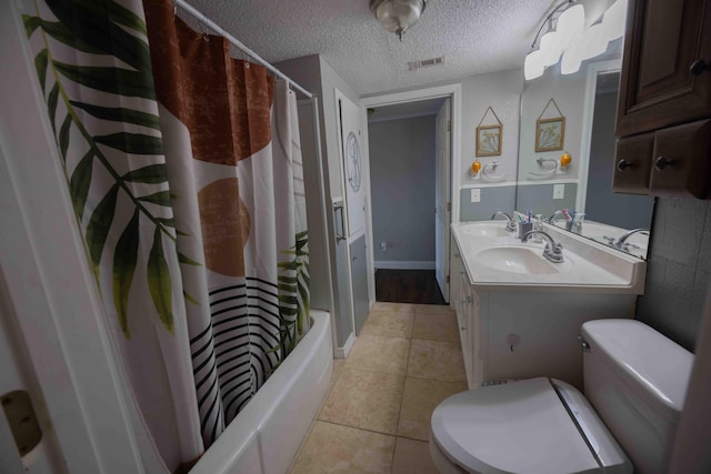 full bathroom featuring vanity, tile patterned floors, toilet, shower / bath combo with shower curtain, and a textured ceiling