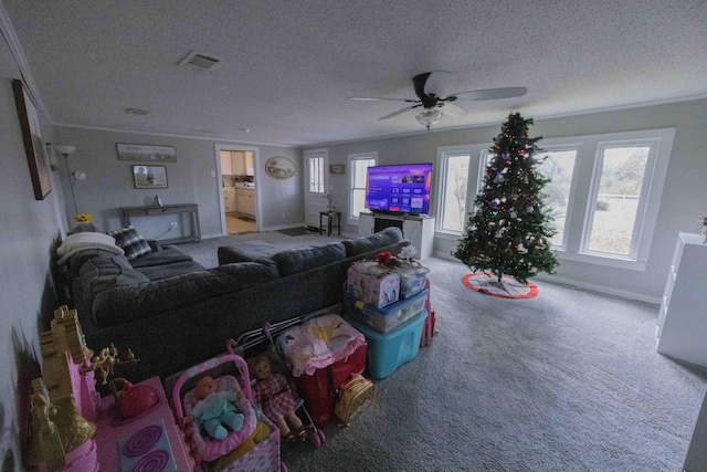 carpeted living room with a textured ceiling, ceiling fan, and crown molding