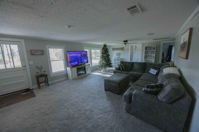 carpeted living room with a textured ceiling, built in features, and ceiling fan