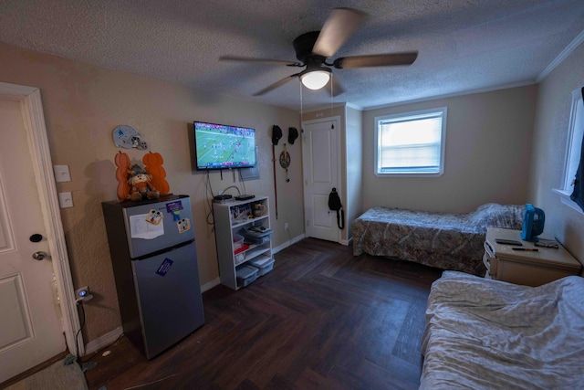 bedroom featuring stainless steel refrigerator, ceiling fan, dark parquet flooring, and a textured ceiling