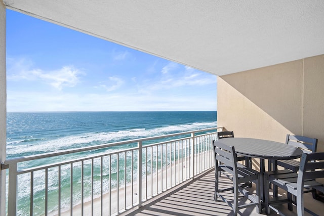 balcony with a beach view and a water view